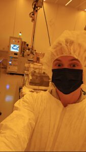 Student in lab equipment showing off internship project.